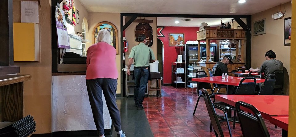 Colorful Mexican restaurant dining room with table seating.
